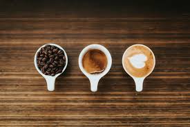 Coffee beans in a cup and latte art with a heart
